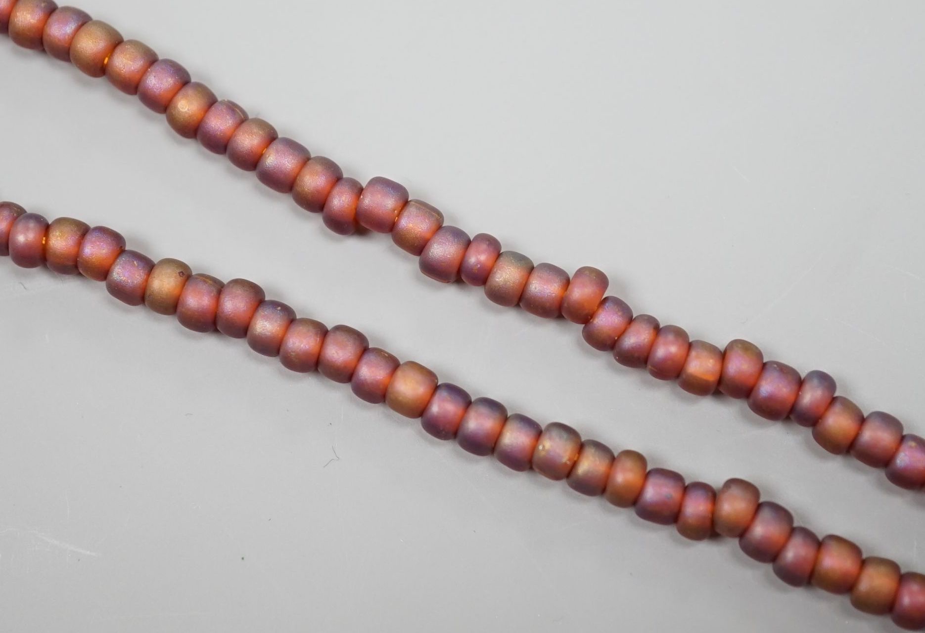 A single strand iridescent art glass bead necklace, with yellow metal clasp, 56cm.
